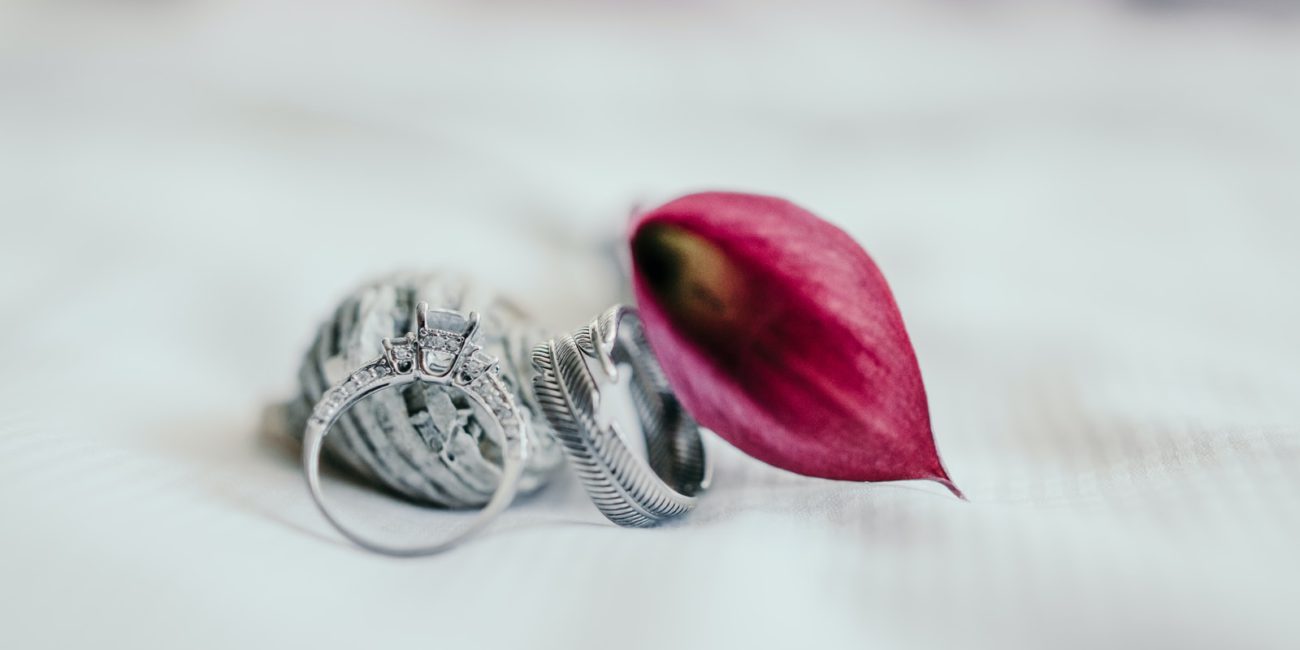 silver-colored ring beside pink flower